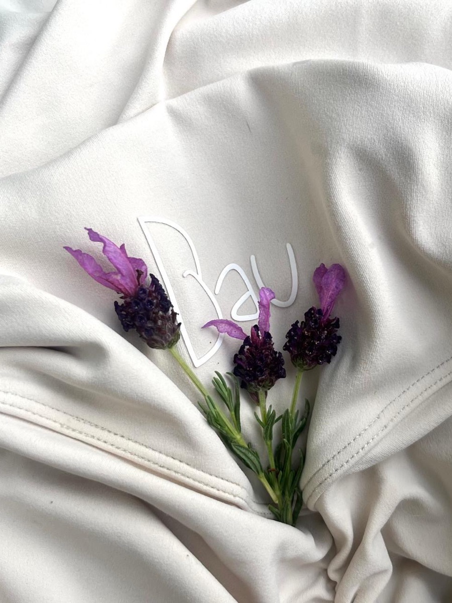 The Bau logo on Macadamia fabric with lavender